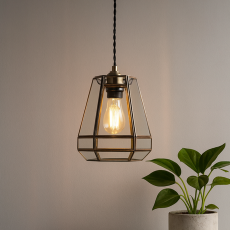 Modern pendant light with a plant on a table against a neutral wall