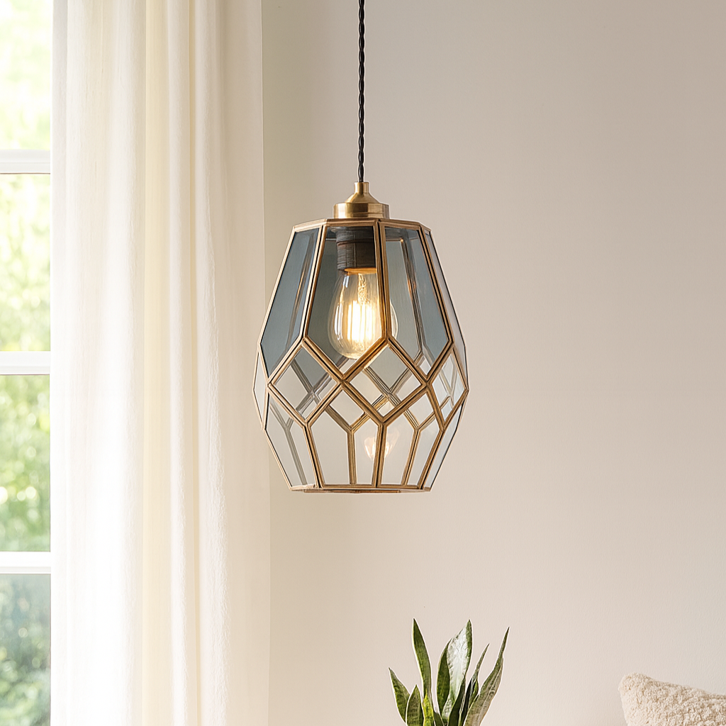 Geometric pendant light hanging above a small round table with a plant and cup.