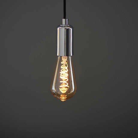 Edison bulb with chrome fitting on a dark background