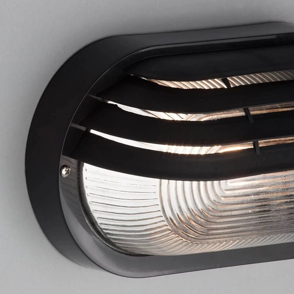 PUCK | Oval Bulkhead Outdoor Glass Wall Light Fitting | E27 | IP44 | Black Caged - LightHub Direct