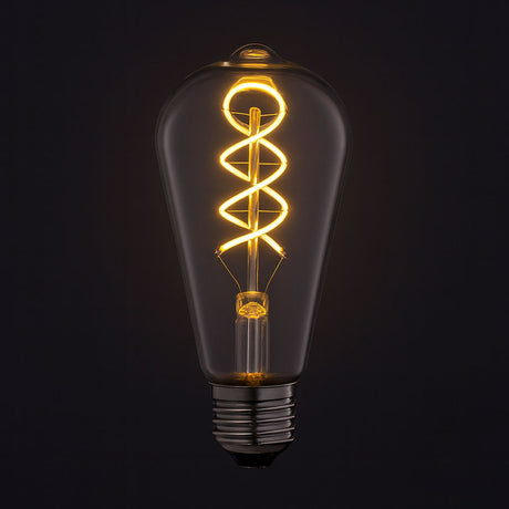 Vintage-style light bulb with coiled filament on a black background