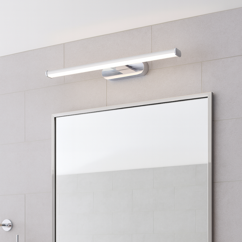 Bathroom mirror with light fixture above, featuring a towel on a rack.