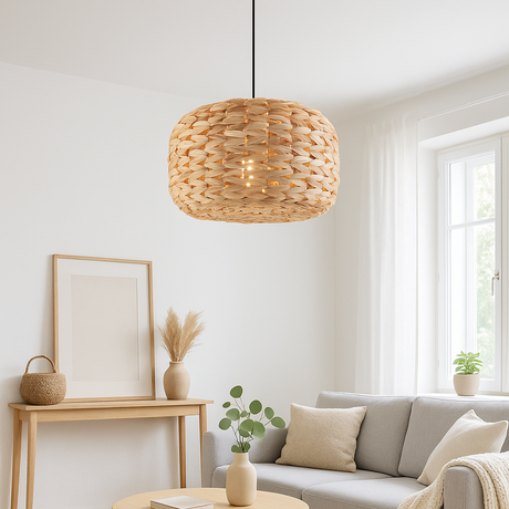 Modern living room with a gray sofa, wooden coffee table, and wicker pendant light.