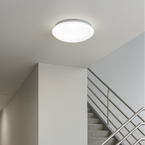 Ceiling light fixture in a stairwell with a neutral color scheme