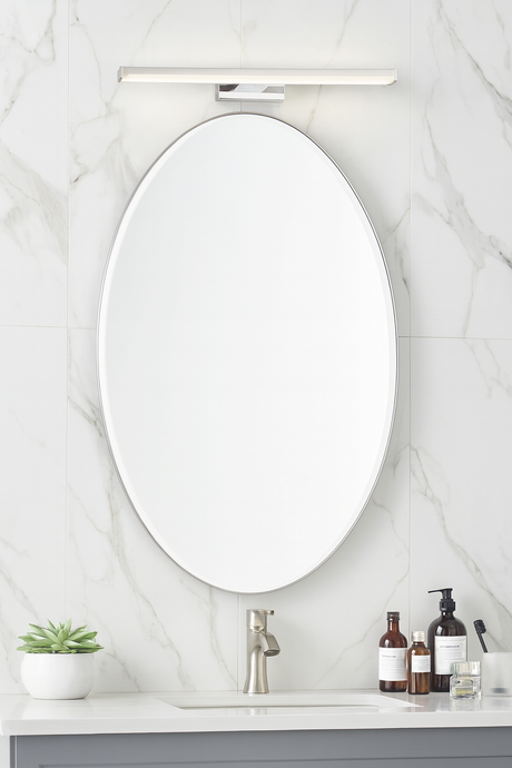Bathroom vanity with oval mirror, sink, and toiletries on a marble wall background